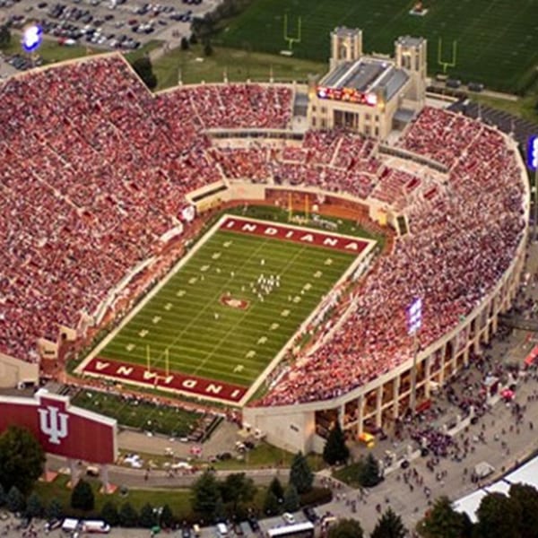 Aerial view of a packed football stadium with "INDIANA" spelled on the field.