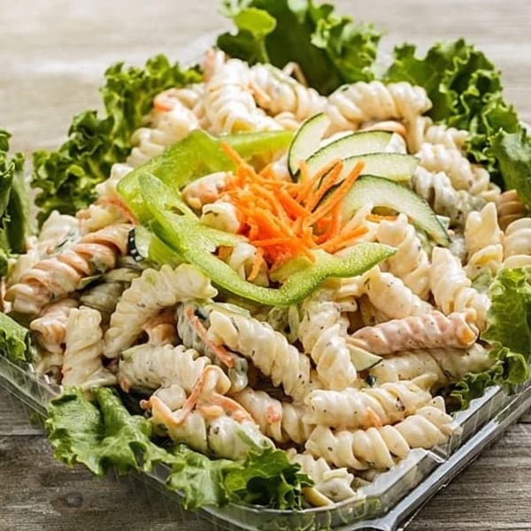 Roly Poly's pasta salad with spiral pasta, lettuce, shredded carrots, and cucumber slices.
